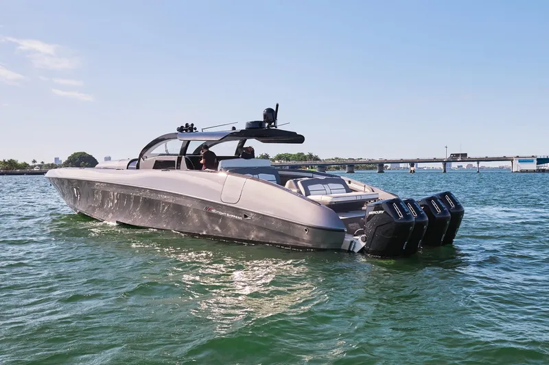 Slide: The Image of 2019 Midnight Express 60' Pied-A-Mer luxury boat on water with triple outboard engines. - 9