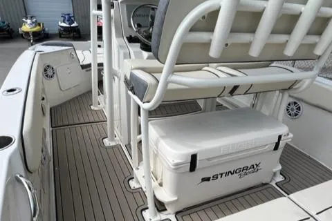 Slide: The Image of 2023 Stingray 206cc boat interior with seating and cooler. - 10