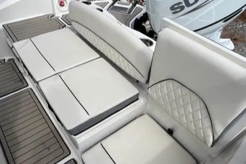 Slide: The Image of 2023 Stingray 206cc boat with white cushioned seating and diamond-stitched backrests. - 11
