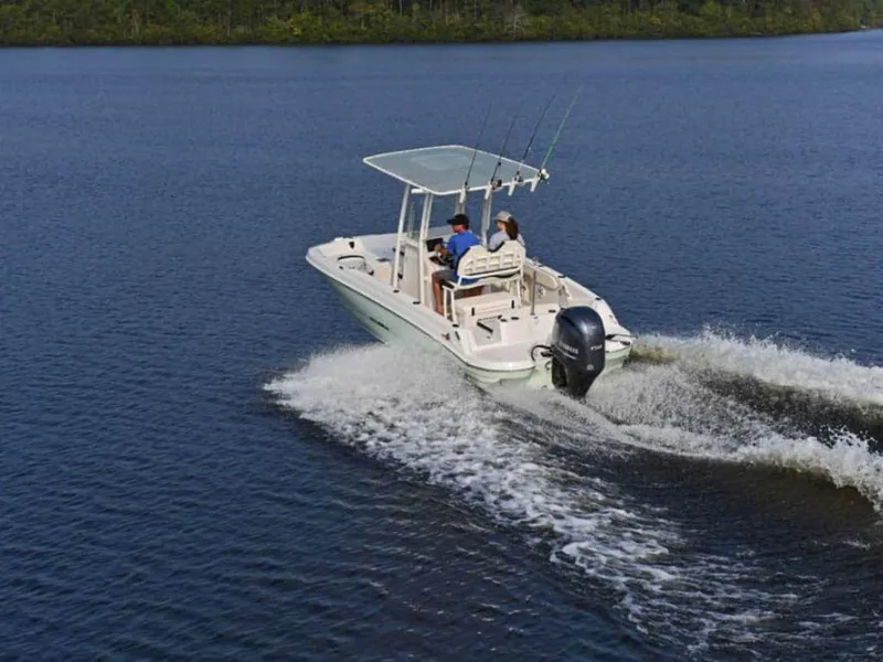 Slide: The Image of 2023 Stingray 206cc boat cruising on a lake. - 14