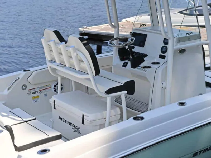 Slide: The Image of 2023 Stingray 206cc boat interior with seating and console. - 2