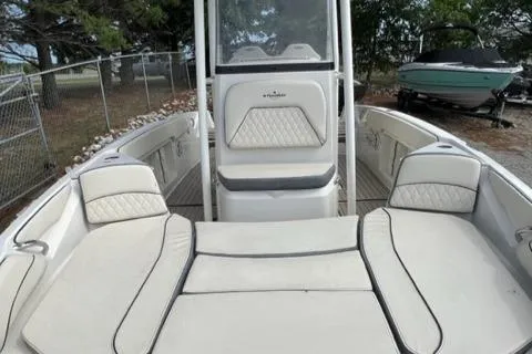 Slide: The Image of 2023 Stingray 206cc boat interior with cushioned seating and center console. - 6