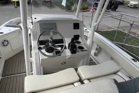 Slide: The Image of 2023 Stingray 206cc boat interior with Garmin navigation system and steering wheel. - 9