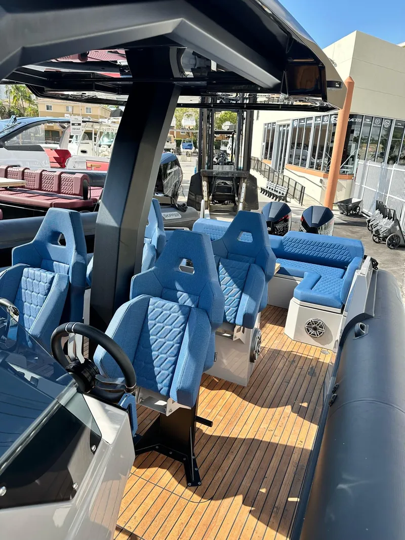 Slide: The Image of 2024 Skipper-BSK 38 boat with blue seats and wooden deck. - 13