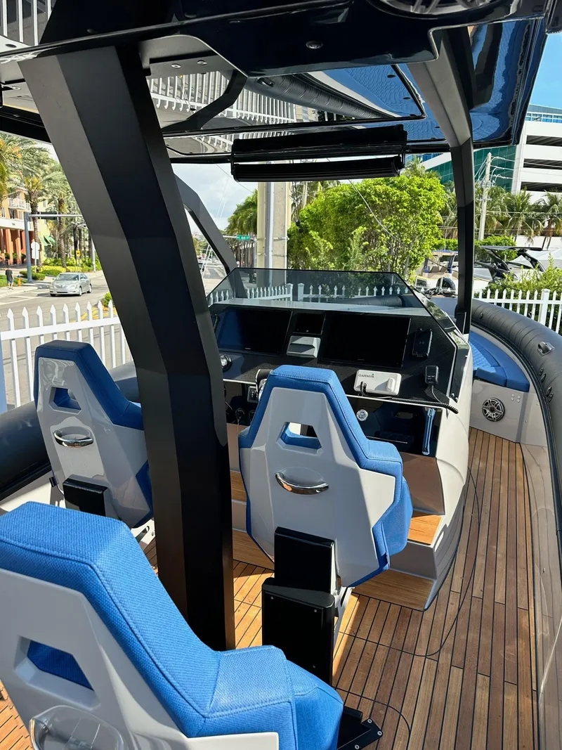 Slide: The Image of 2024 Skipper-BSK 38 boat interior with blue seats and modern dashboard. - 14