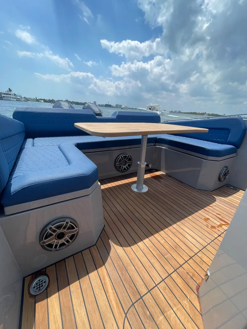 Slide: The Image of Skipper-BSK 38 boat 2024 model with blue seating and wooden deck. - 19