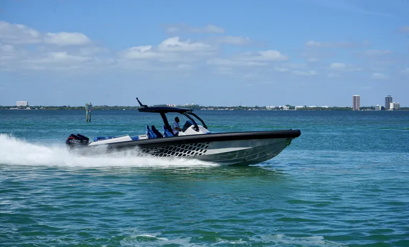 Slide: The Image of 2024 Skipper-BSK 38 speedboat cruising on a sunny day. - 2