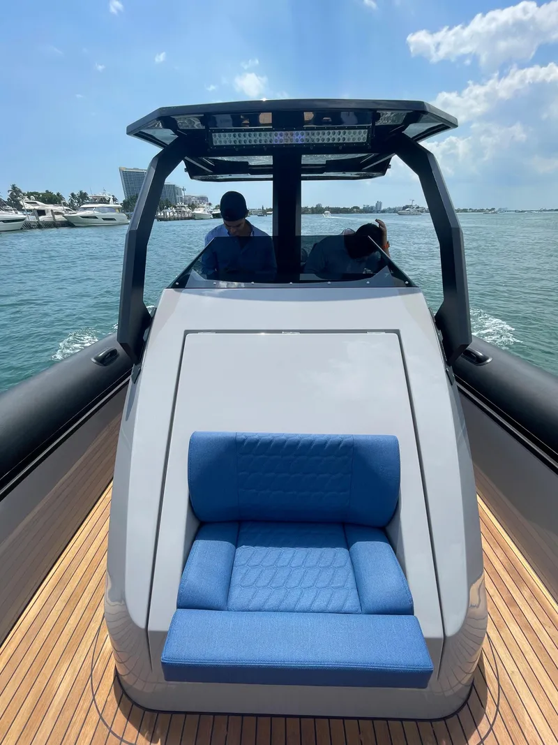 Slide: The Image of 2024 Skipper-BSK 38 luxury boat with blue seating and modern design on the water. - 22