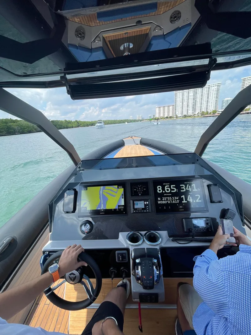 Slide: The Image of 2024 Skipper-BSK 38 boat dashboard with navigation and control systems on water. - 24