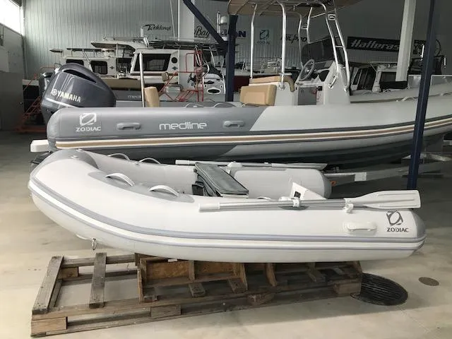 Slide: The Image of 2023 Zodiac Cadet 270 RIB ALU PVC inflatable boat in stock, displayed in a showroom. - 2