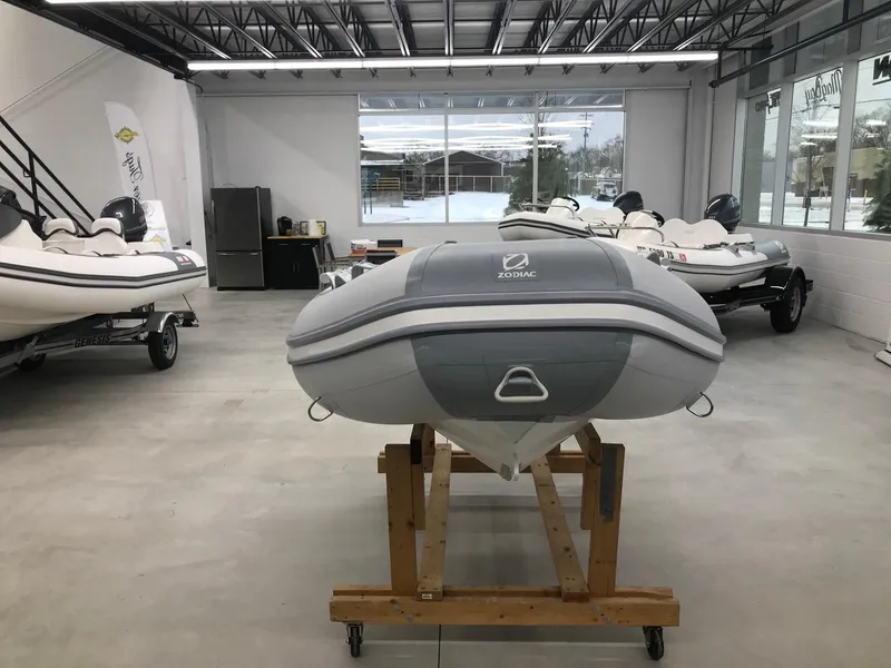 Slide: The Image of 2023 Zodiac Cadet 300 RIB ALU PVC boat displayed in a showroom. - 2
