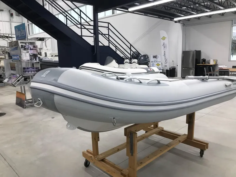 Slide: The Image of 2023 Zodiac Cadet 300 RIB ALU PVC boat displayed in showroom. - 3