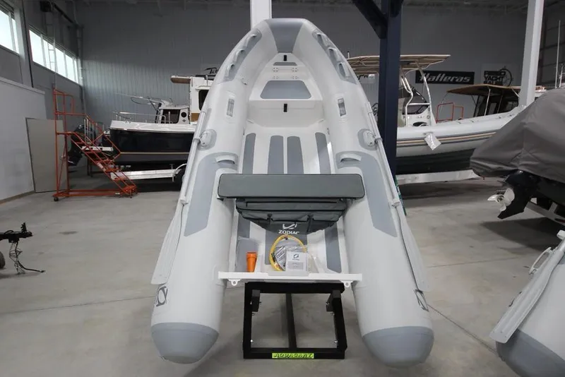 The Image of 2023 Zodiac Cadet 330 DL RIB ALU PVC inflatable boat in stock, displayed in a showroom. - 0