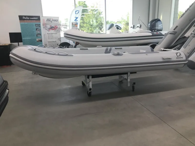 Slide: The Image of 2023 Zodiac Cadet 360 DL RIB ALU PVC inflatable boat displayed indoors. - 2