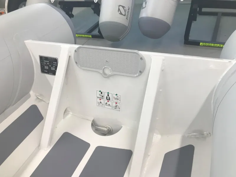 Slide: The Image of 2023 Zodiac Cadet 360 DL RIB ALU PVC boat interior, white and gray seating. - 4