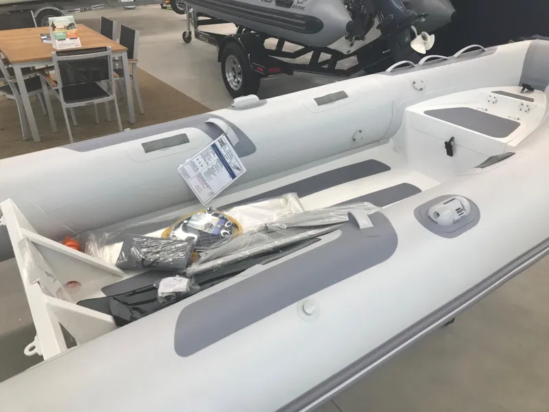 Slide: The Image of 2023 Zodiac Cadet 360 DL RIB ALU PVC inflatable boat in stock, displayed indoors. - 5