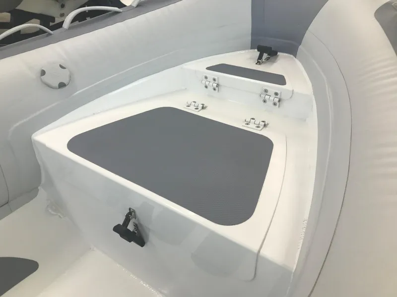 Slide: The Image of 2023 Zodiac Cadet 360 DL RIB ALU PVC boat interior with storage compartments. - 6