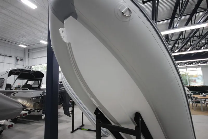 Slide: The Image of 2023 Zodiac Cadet 330 DL RIB ALU PVC boat displayed in showroom. - 6