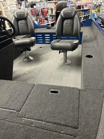 Slide: The Image of 2023 Lund 1650 Angler SS boat storage compartment with open lid. - 3