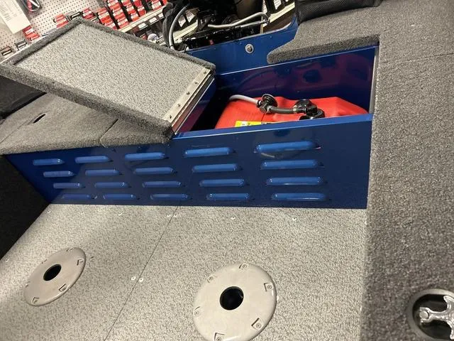 Slide: The Image of 2023 Lund 1650 Angler SS fishing boat interior with storage compartments and seating. - 9