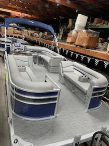 Slide: The Image of 2023 Bennington 22 SL pontoon boat in a storage facility. - 1