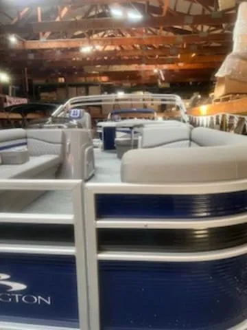 Slide: The Image of 2023 Bennington 22 SL pontoon boat docked, side view with SX21 marking. - 3