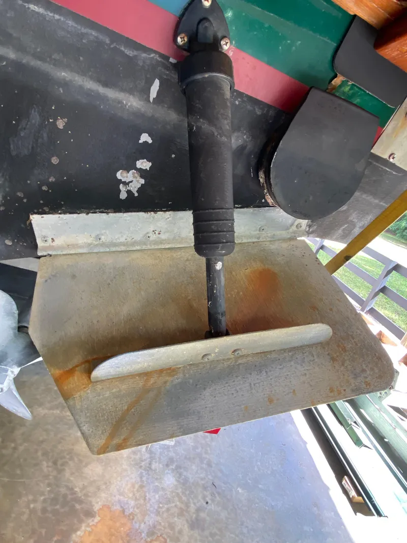 Slide: The Image of Trim tab of a 1988 Blackfin 29 Flybridge boat, showing rust and wear. - 27