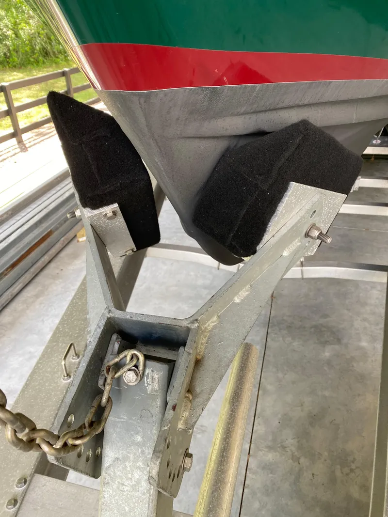 Slide: The Image of 1988 Blackfin 29 Flybridge boat on trailer, secured with chain and padded supports. - 31