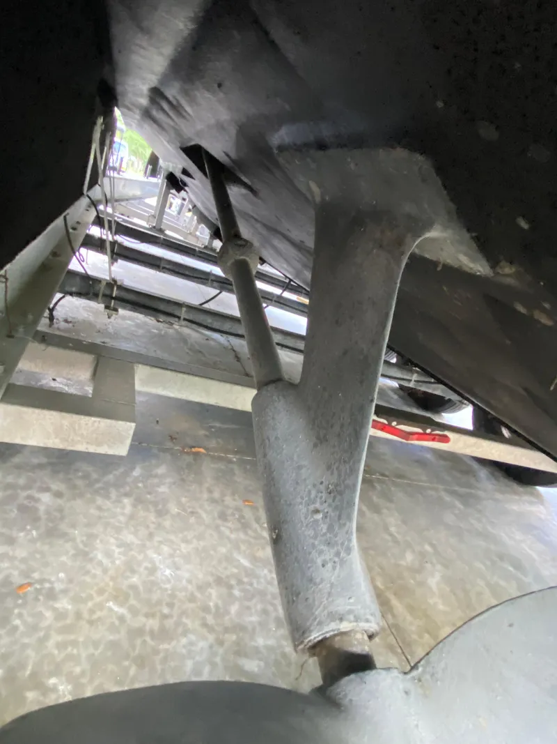 Slide: The Image of Underneath view of a 1988 Blackfin 29 Flybridge boat on a trailer. - 32