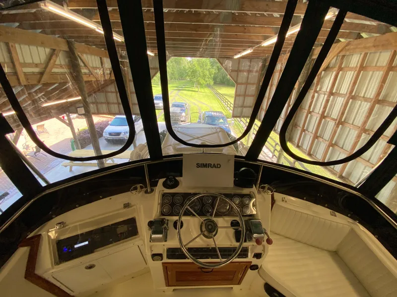 Slide: The Image of 1988 Blackfin 29 Flybridge interior view with steering wheel and Simrad equipment. - 36