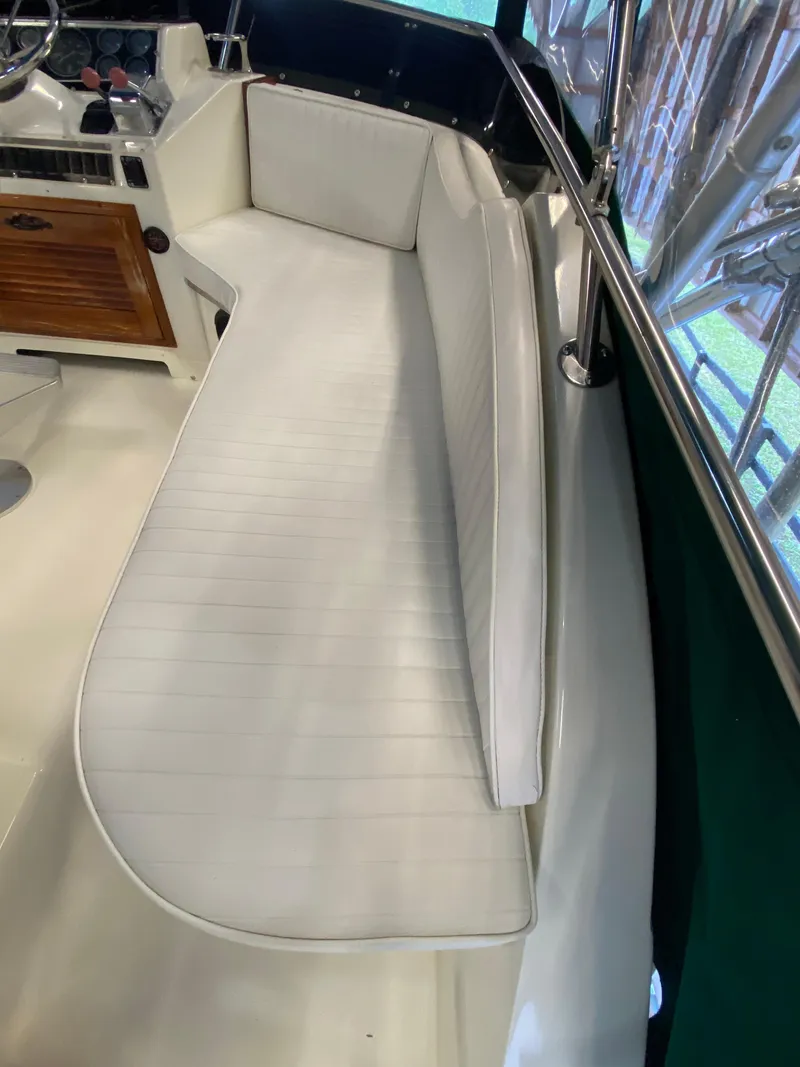 Slide: The Image of 1988 Blackfin 29 Flybridge interior with white seating and wooden dashboard. - 40