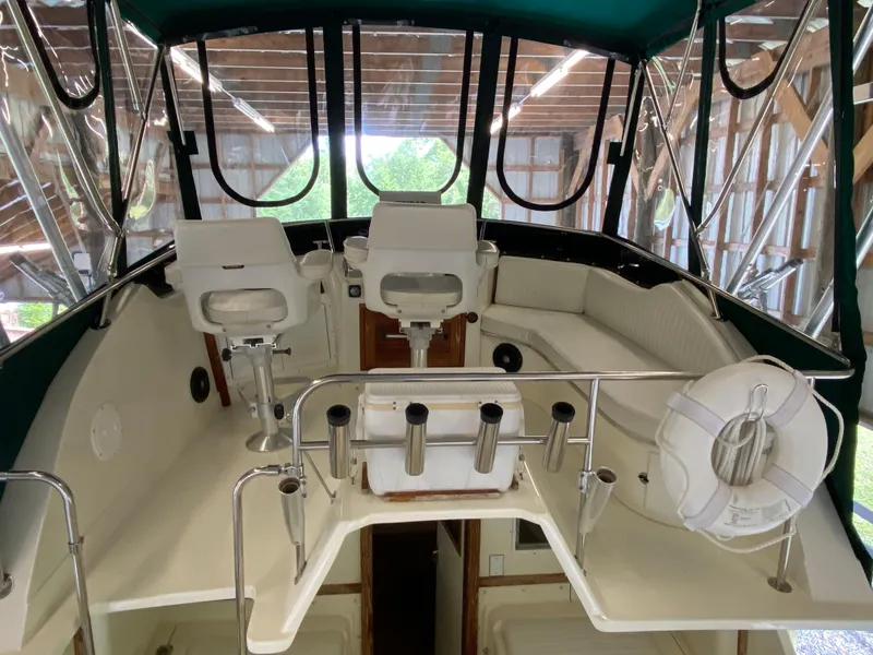 Slide: The Image of 1988 Blackfin 29 Flybridge interior with seating and helm, under a covered structure. - 41