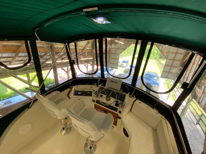 Slide: The Image of 1988 Blackfin 29 Flybridge interior with helm, seating, and navigation equipment. - 44