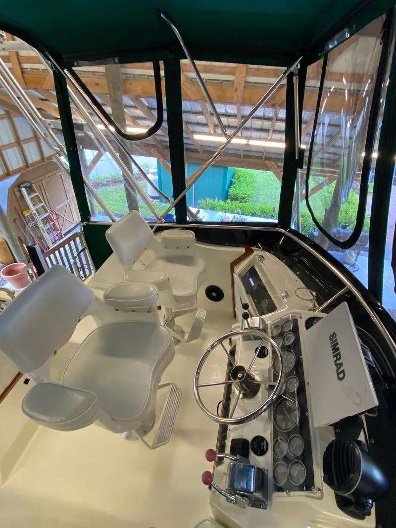 Slide: The Image of 1988 Blackfin 29 Flybridge interior with steering wheel, seats, and navigation equipment. - 45