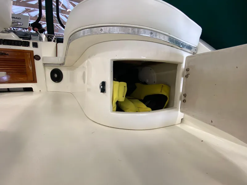 Slide: The Image of 1988 Blackfin 29 Flybridge interior storage with yellow life jackets visible. - 47