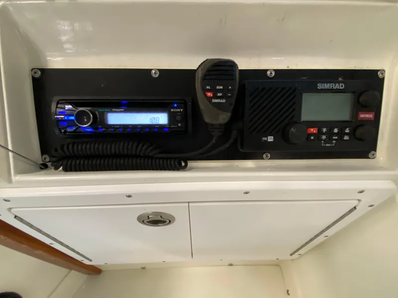 Slide: The Image of 1988 Blackfin 29 Flybridge dashboard with Sony stereo and Simrad marine radio. - 49