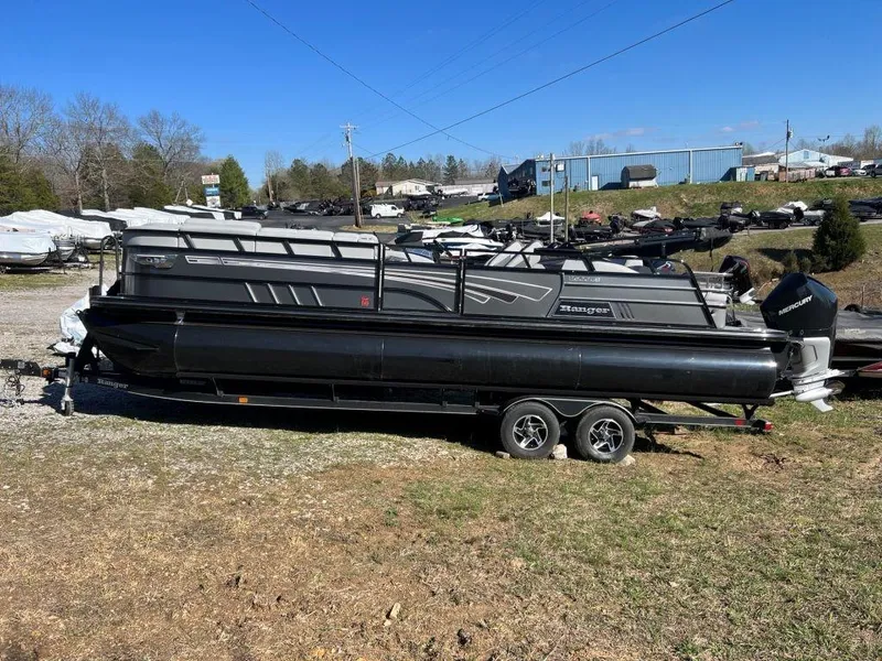 The Image of 2023 Ranger 2500LS pontoon boat on a trailer in a boatyard. - 1