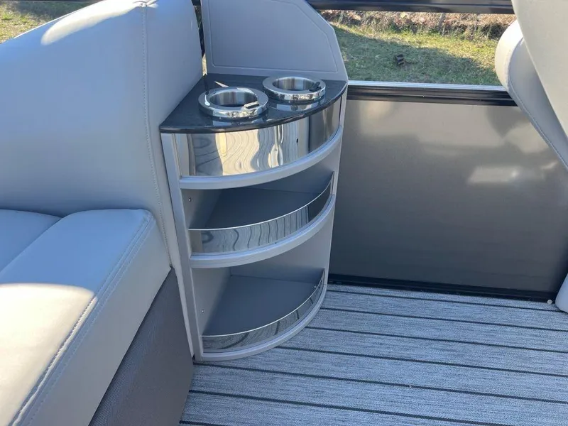 Slide: The Image of 2023 Ranger 2500LS boat interior with cup holders and storage shelves. - 10