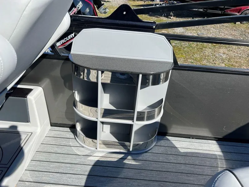 Slide: The Image of 2023 Ranger 2500LS boat interior with storage compartment and Mercury engine. - 5