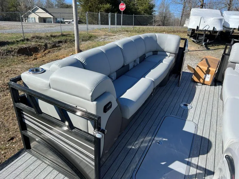 Slide: The Image of 2023 Ranger 2500LS pontoon boat with gray seating and spacious deck. - 6