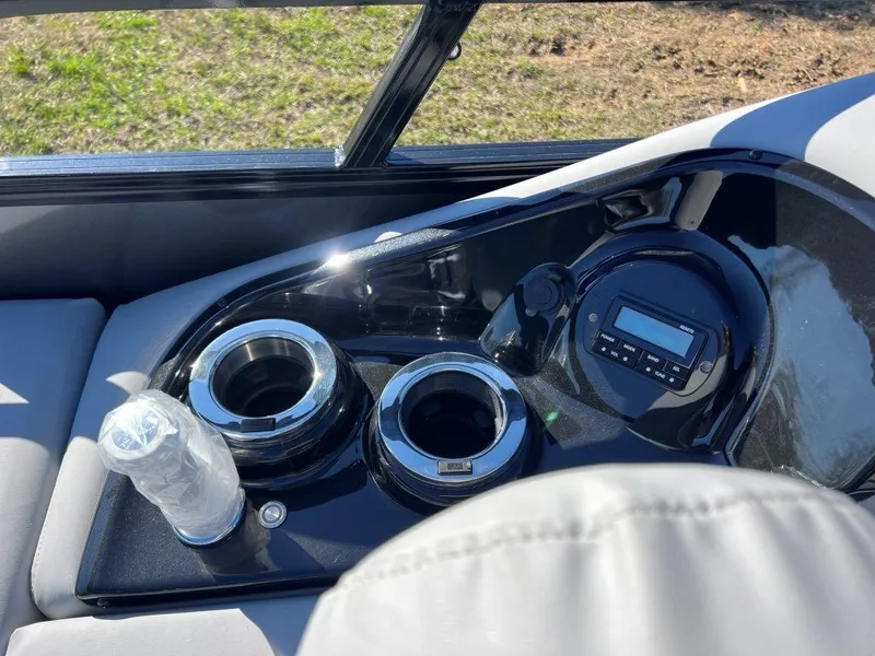 Slide: The Image of 2023 Ranger 2500LS boat console with cup holders and control panel. - 9