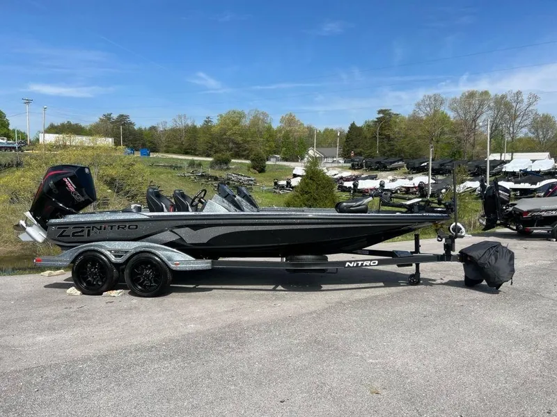 The Image of 2023 Nitro Z21 XL Pro bass boat on trailer in outdoor setting. - 1