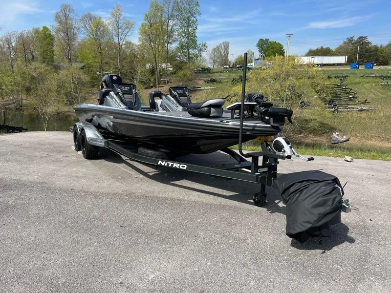 Slide: The Image of 2023 Nitro Z21 XL Pro bass boat on a trailer in a scenic outdoor setting. - 3