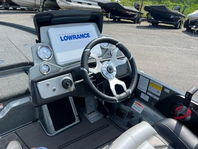 Slide: The Image of 2023 Nitro Z21 XL Pro boat dashboard with Lowrance electronics and steering wheel. - 6