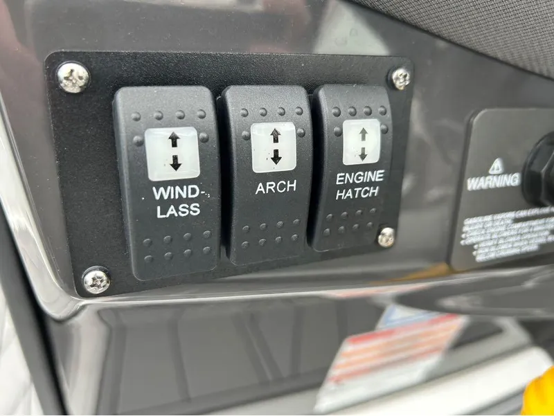 Slide: The Image of Control panel switches on a 2022 Monterey 298 Super Sport boat. - 11