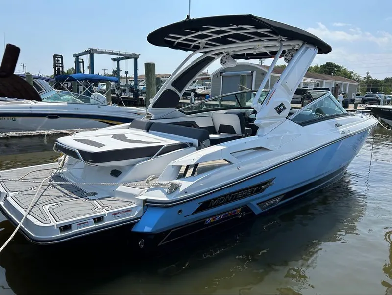 Slide: The Image of 2022 Monterey 298 Super Sport boat docked in marina. - 14