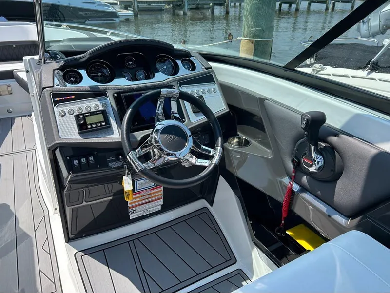 Slide: The Image of 2022 Monterey 298 Super Sport boat cockpit with modern steering and controls. - 3