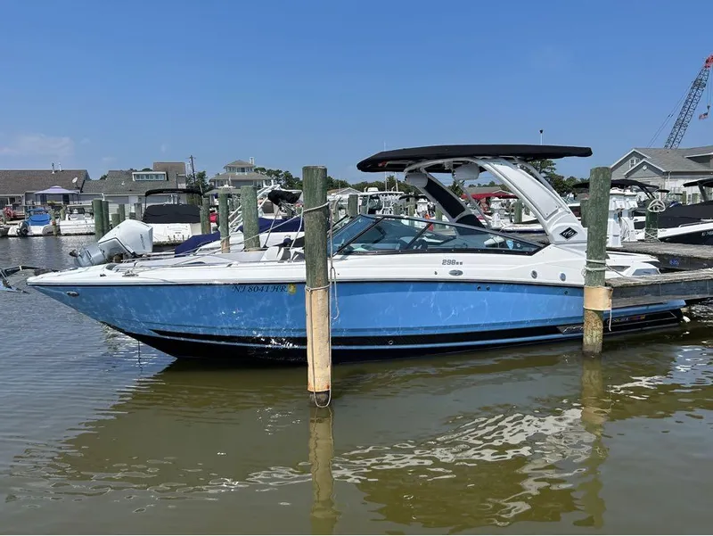 Slide: The Image of 2022 Monterey 298 Super Sport boat docked in a marina. - 5