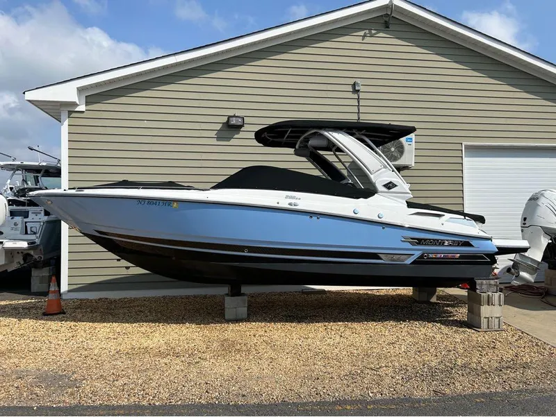 Slide: The Image of 2022 Monterey 298 Super Sport boat displayed on blocks outside a garage. - 6