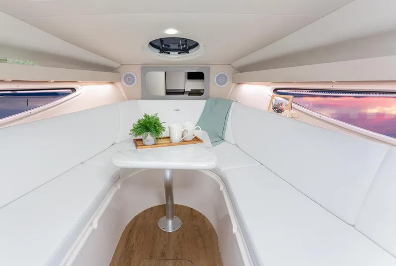 Slide: The Image of Interior of 2023 Regal 28 Express boat with white seating and table. - 12
